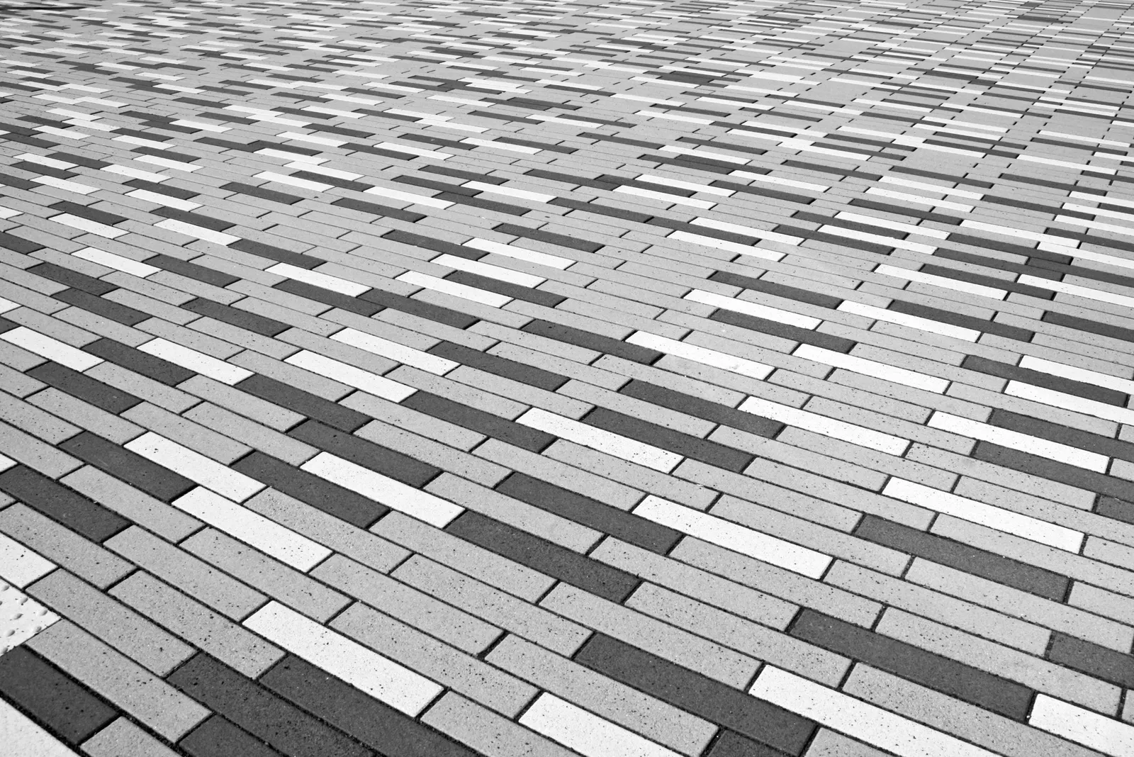 Staggered rectangular pavers on a patio with garden borders